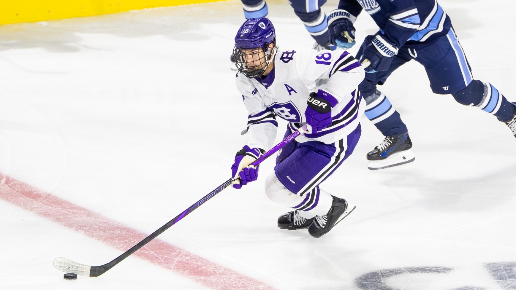 Ty Gagno skates with the puck