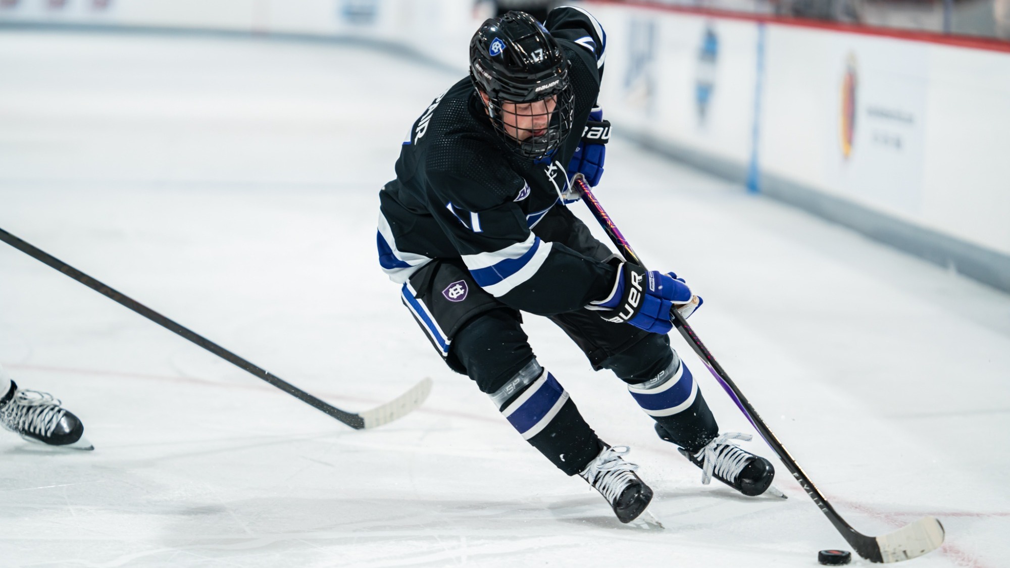 Bode Sampair skates with the puck at Sacred Heart