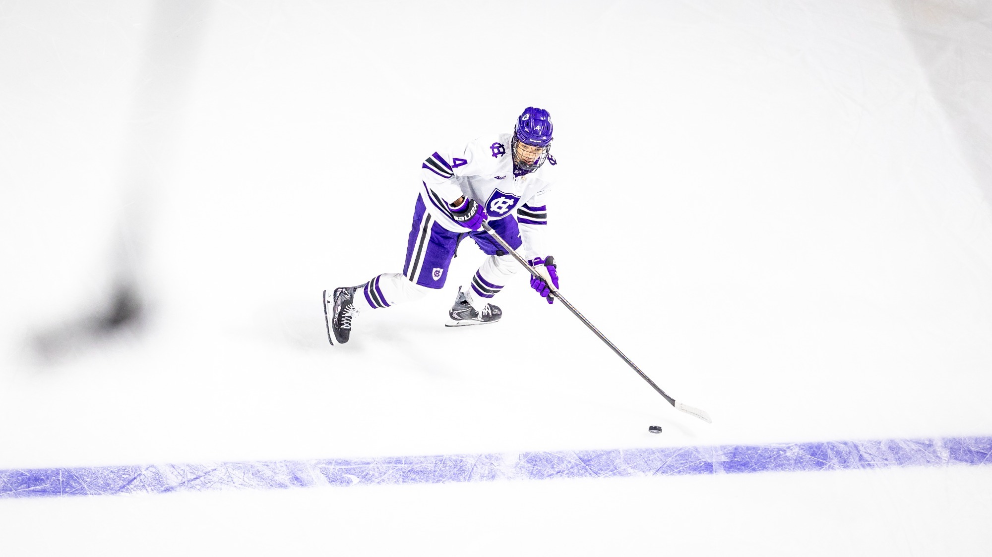 Anthony Biakabutuka skates with the puck against Maine