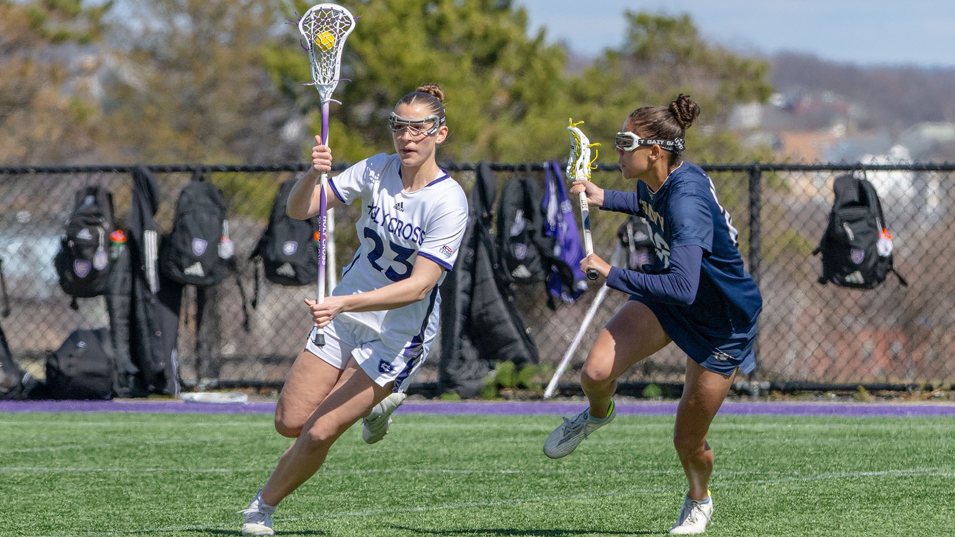 Tess Prunier with the ball against a Navy defender