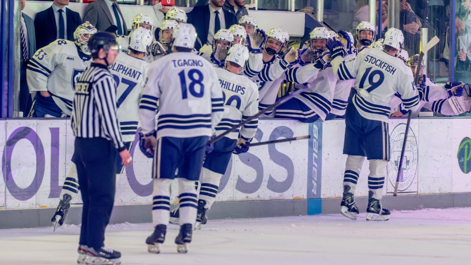 men's ice hockey celebrates a goal against RIT