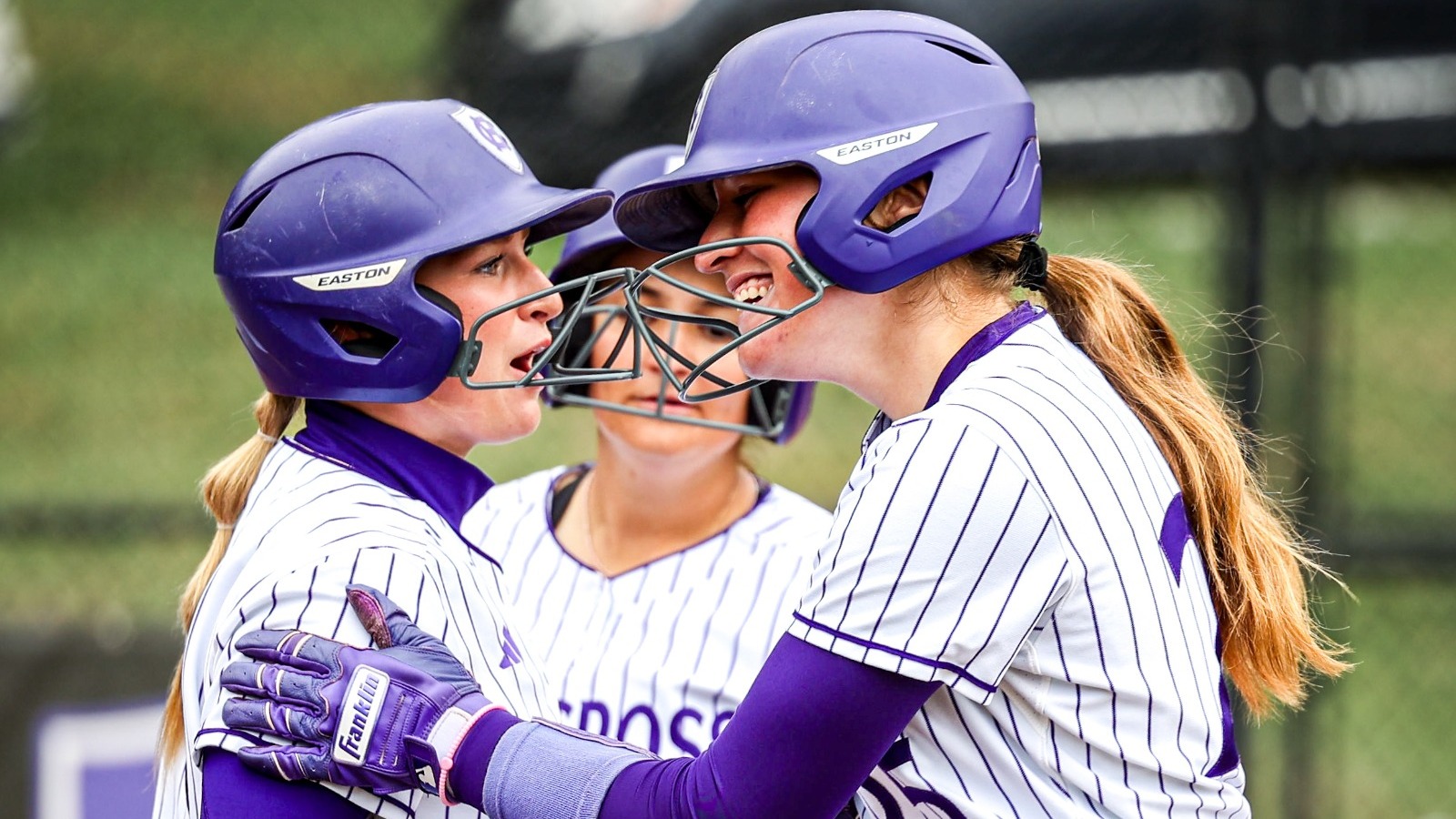 Softball team huddle Bella HR Lafayette Apr. 18