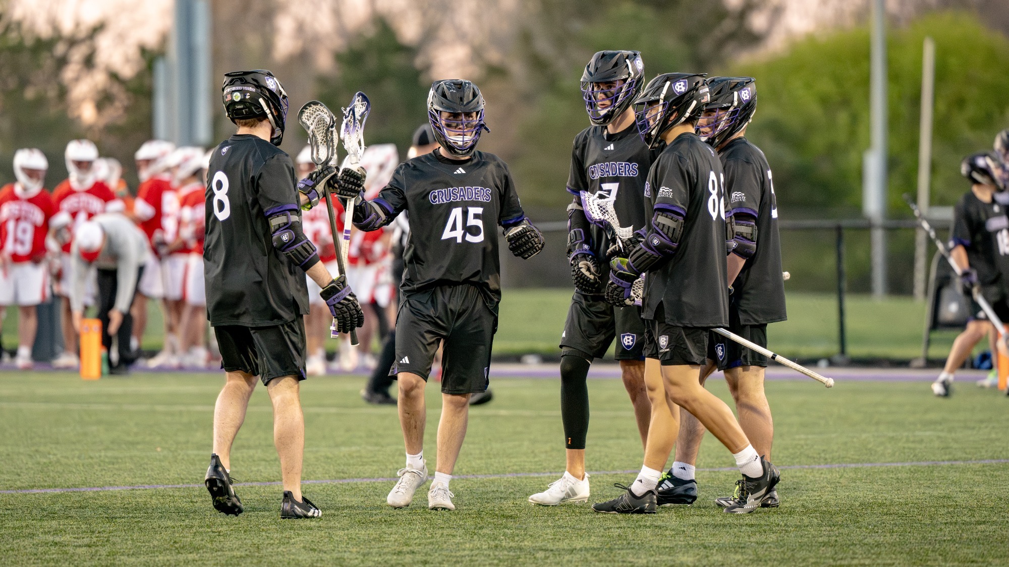 Men's lacrosse celebrates a goal against Boston University