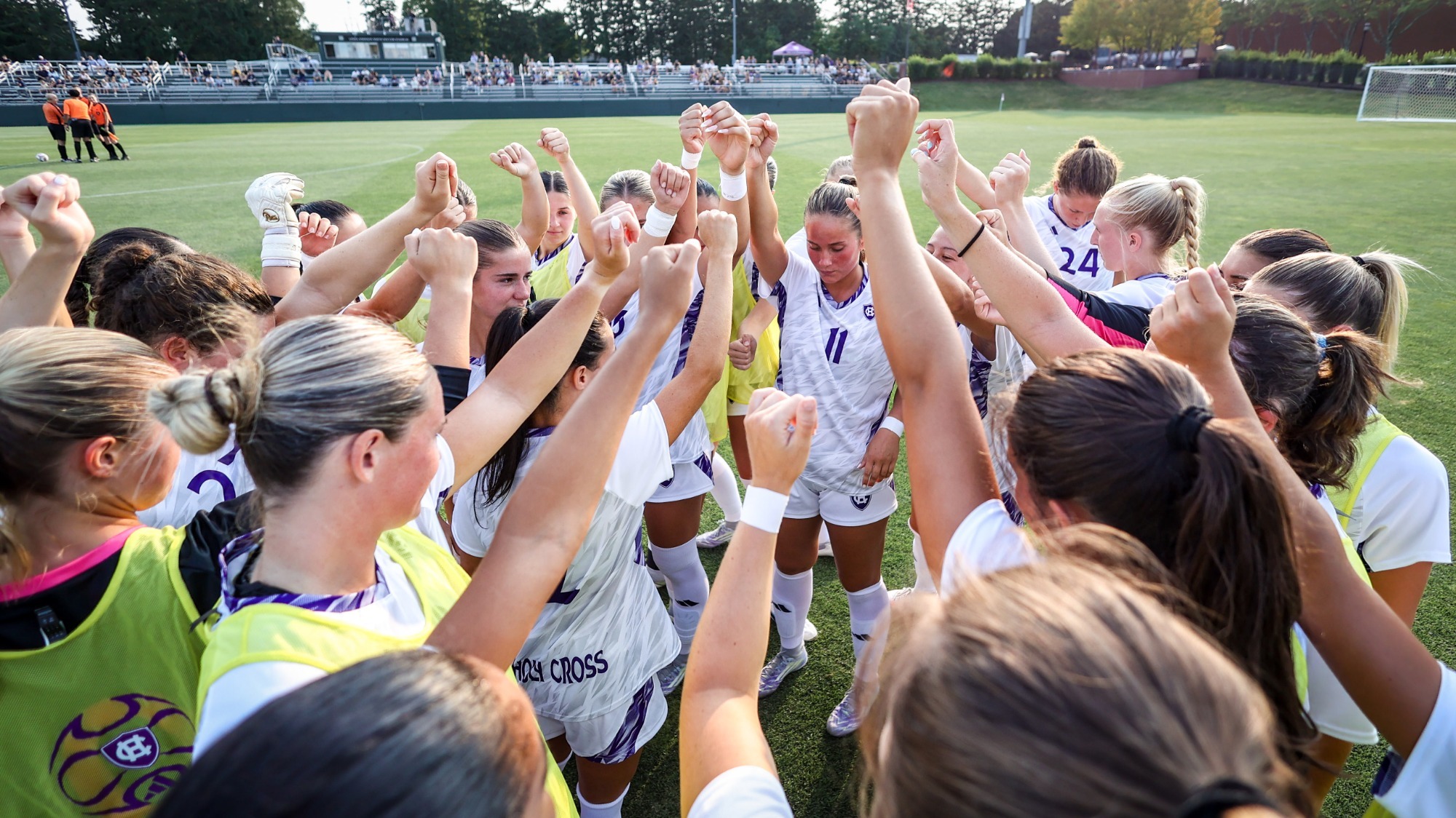 Women's soccer team huddle 2026 opener