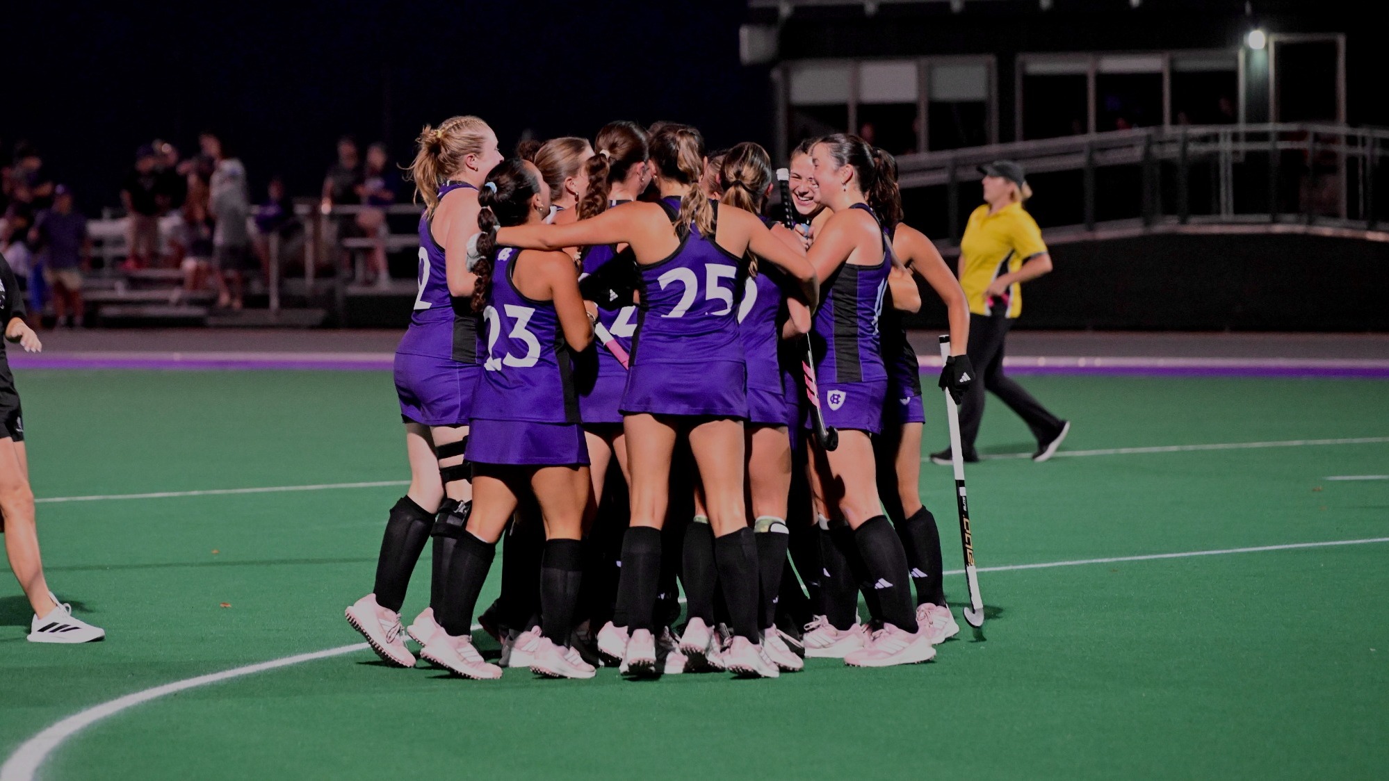 field hockey celebrates after defeating Stonehill