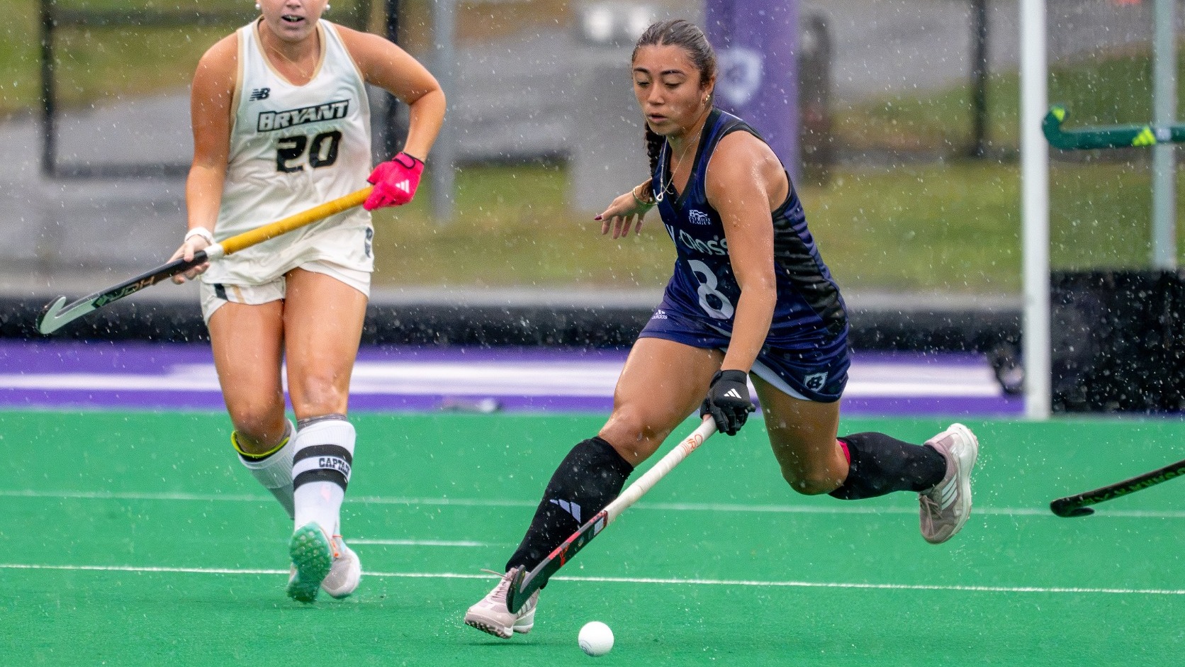 Marianna MacLean dribbles the ball down the field against Bryant
