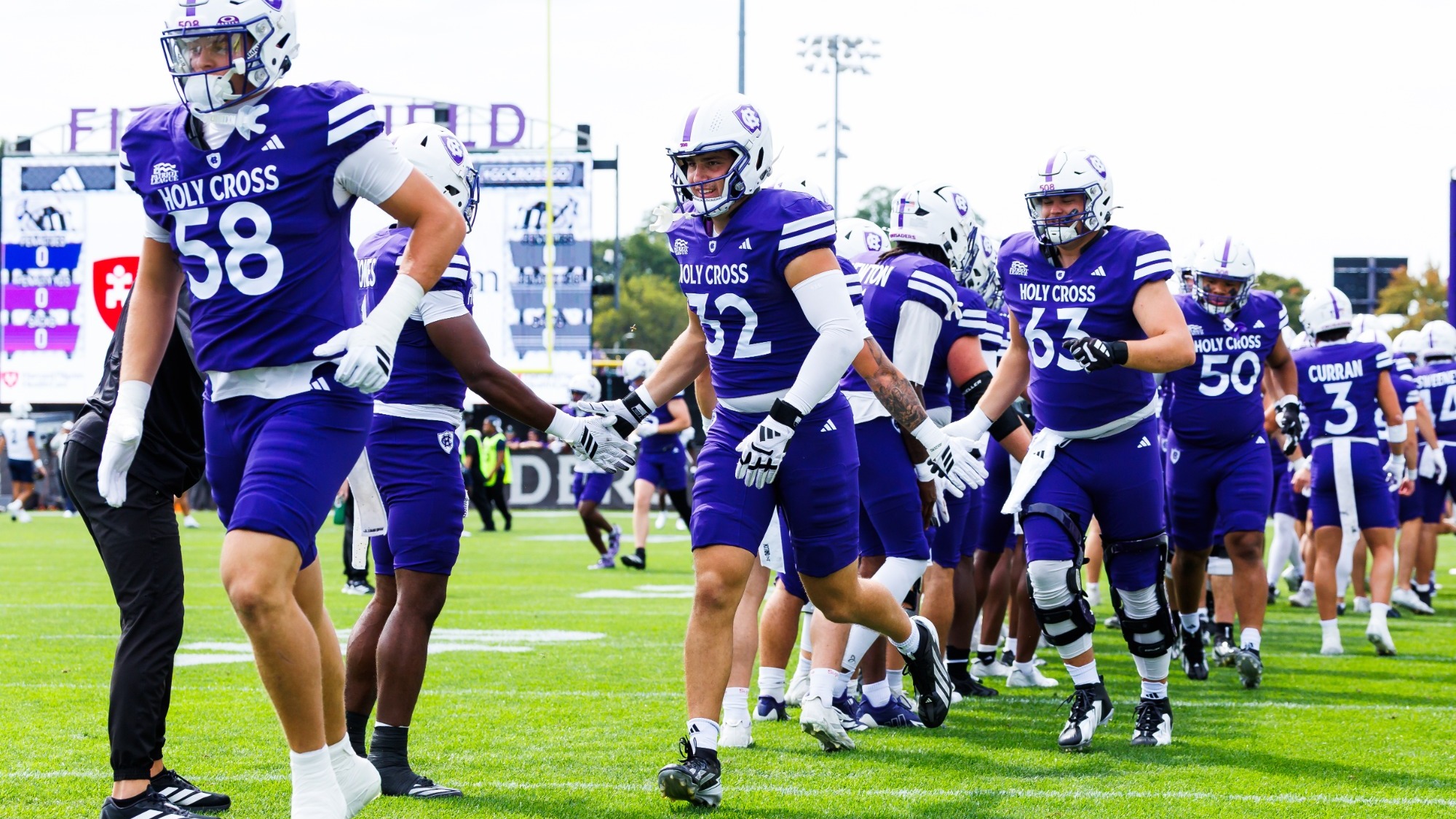 Football team running out to field