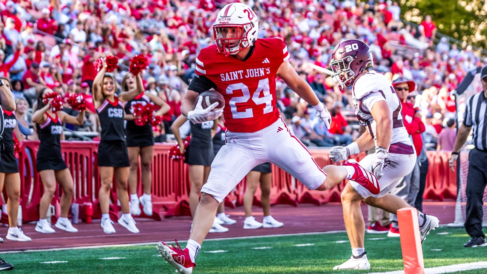 Wyatt McCabe scoring a touchdown against Augsburg. Photo by Ella Carlson