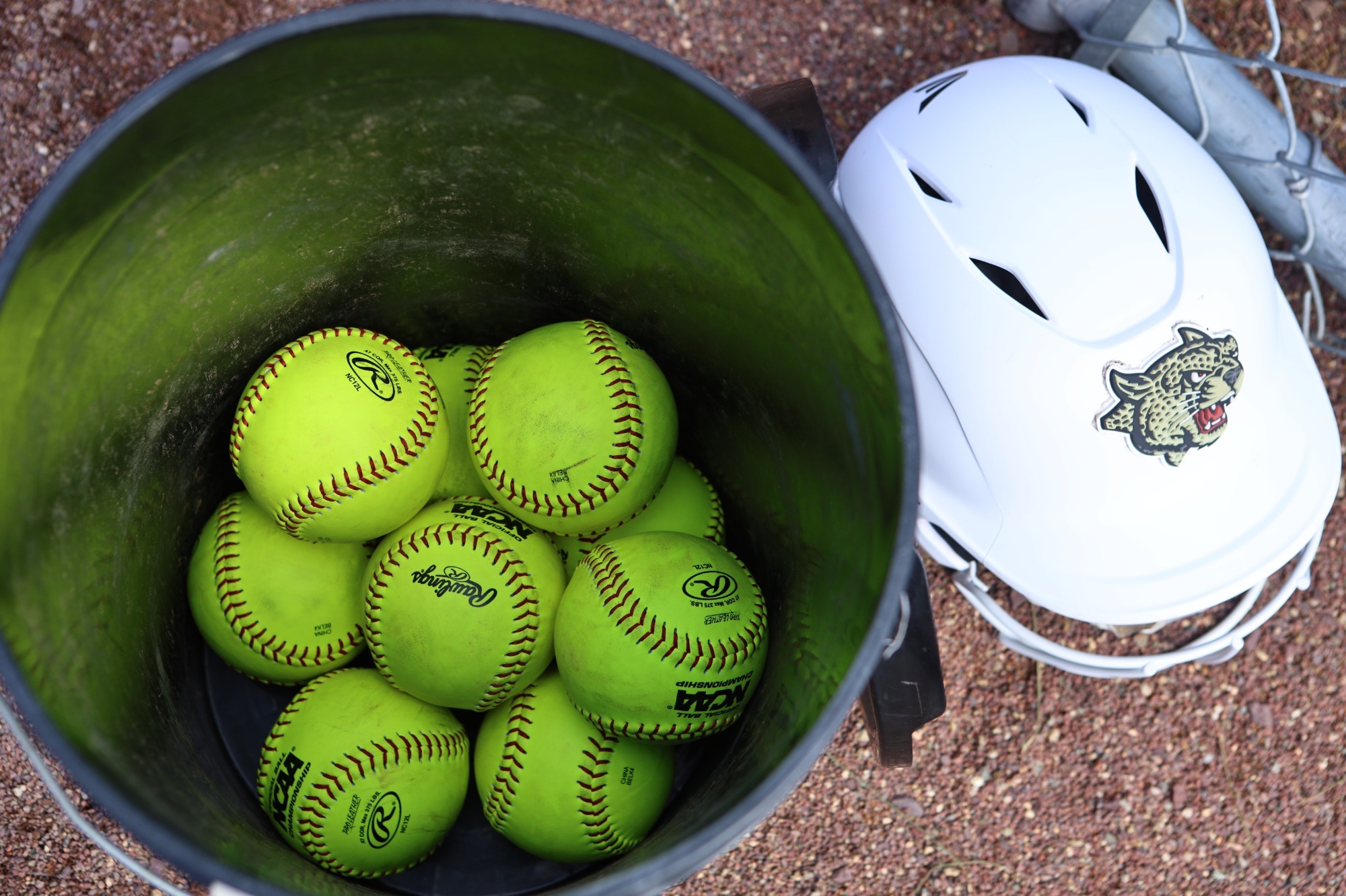 softballs and a helmet