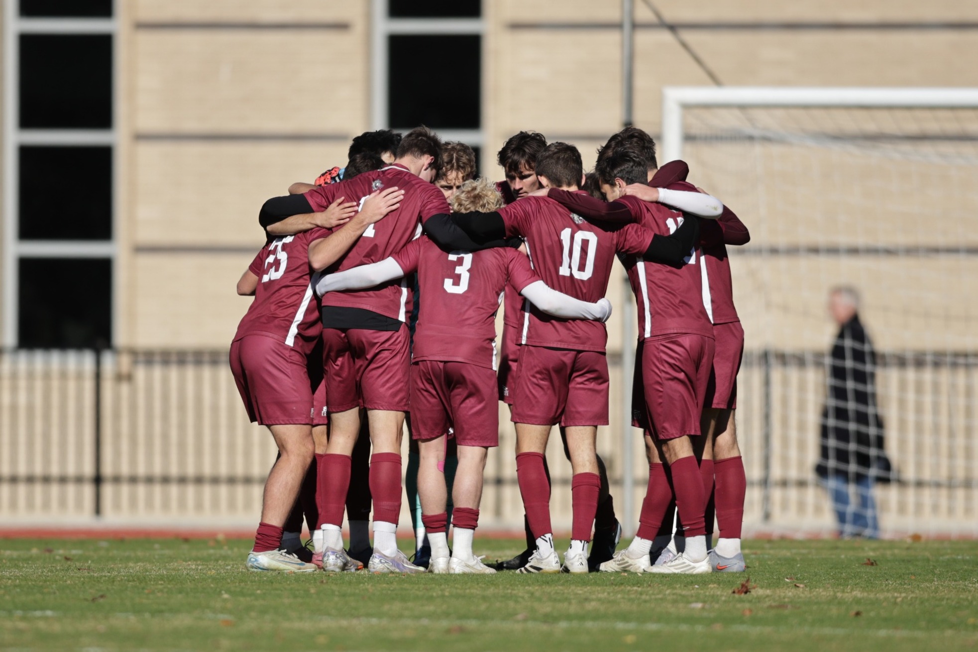 mens soccer team huddle