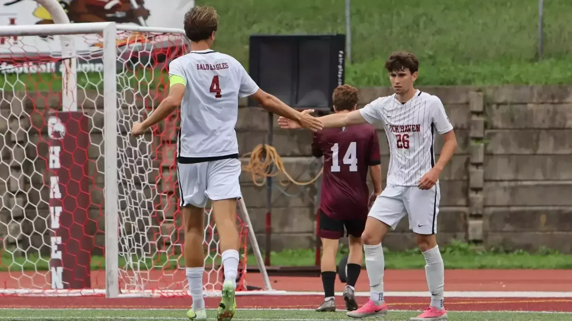 Danny Ogan and Austen Veach slap hands in action against Bloomsburg