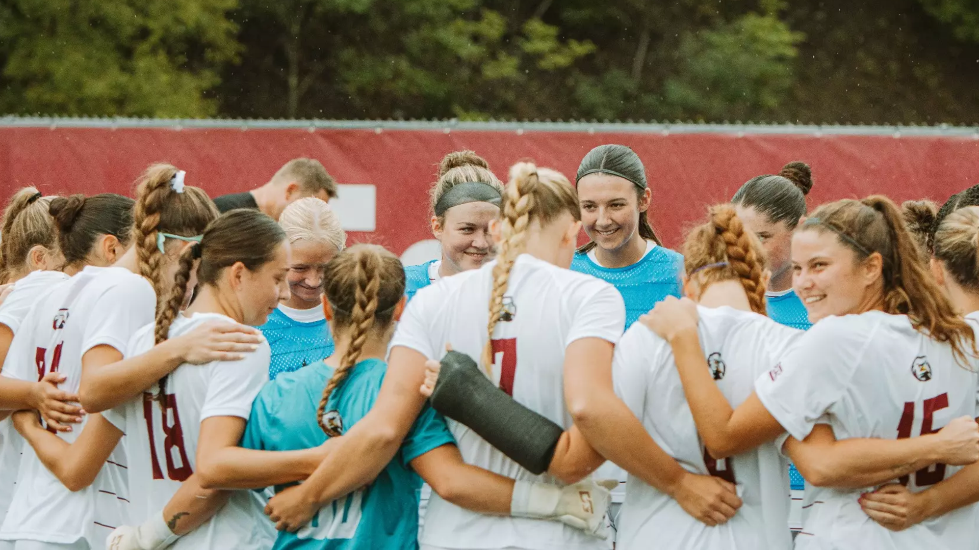Women's soccer team in a pregame huddle prior to the start of play against Charleston