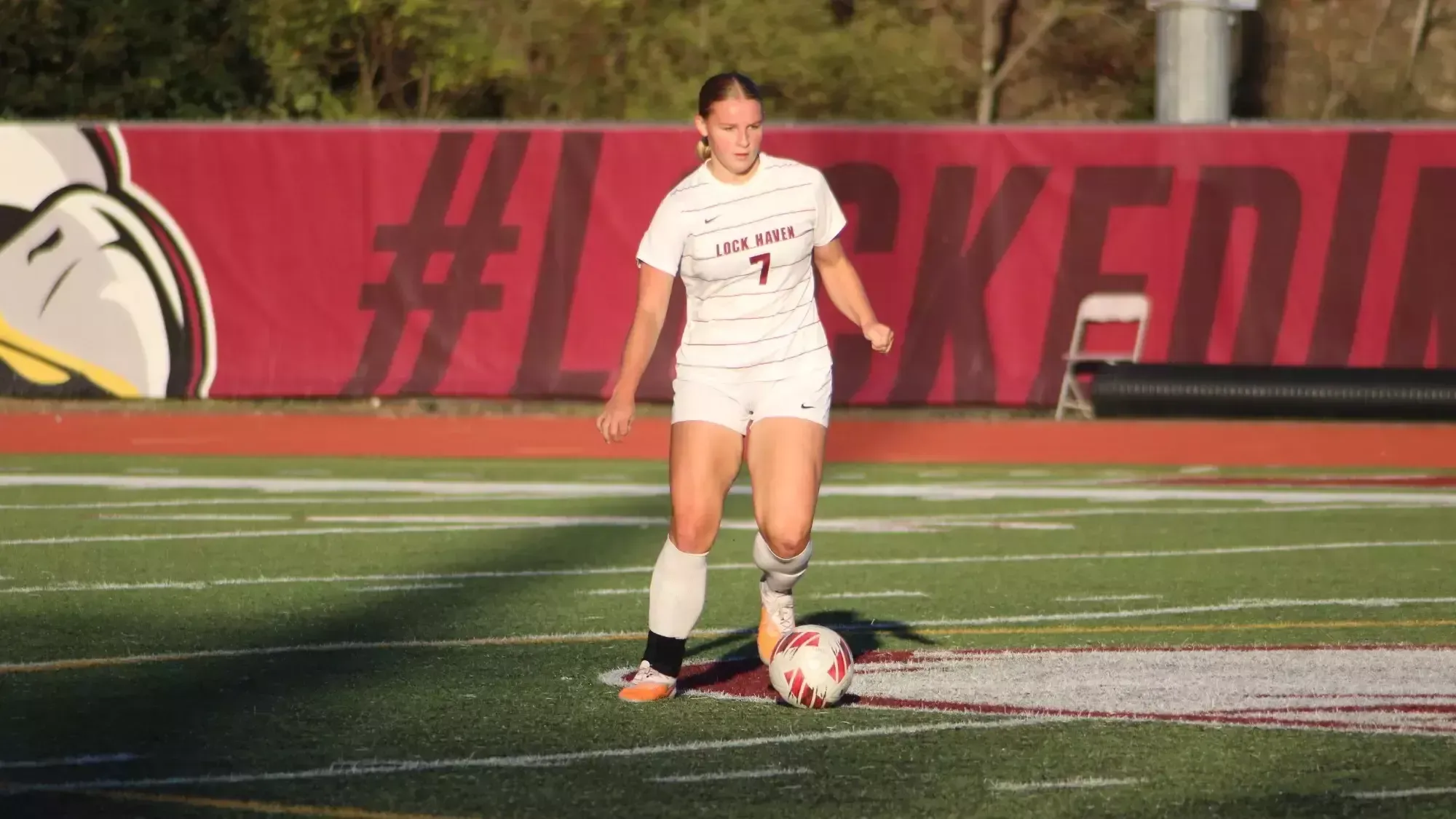 Allie Green dribbled and looks to pass in women's soccer action