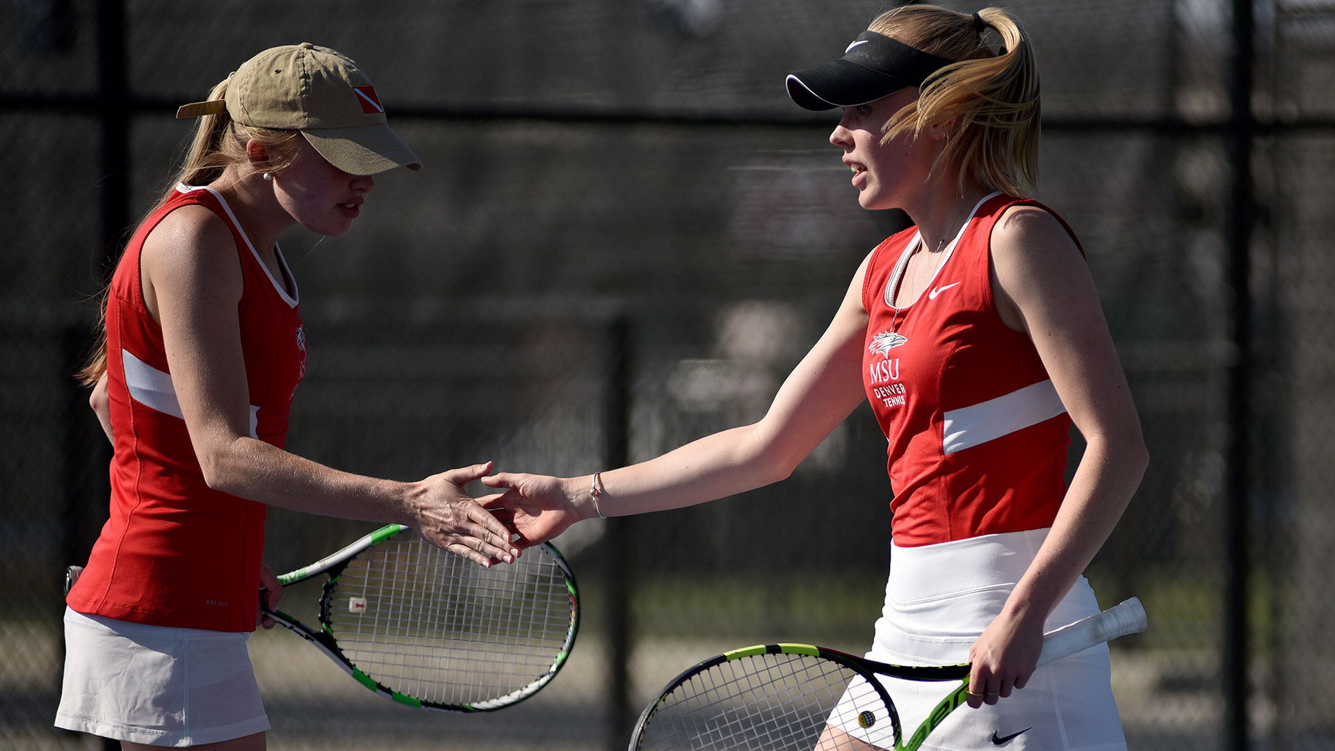 Two MSu Denver Women's Tennis player shaking hands 