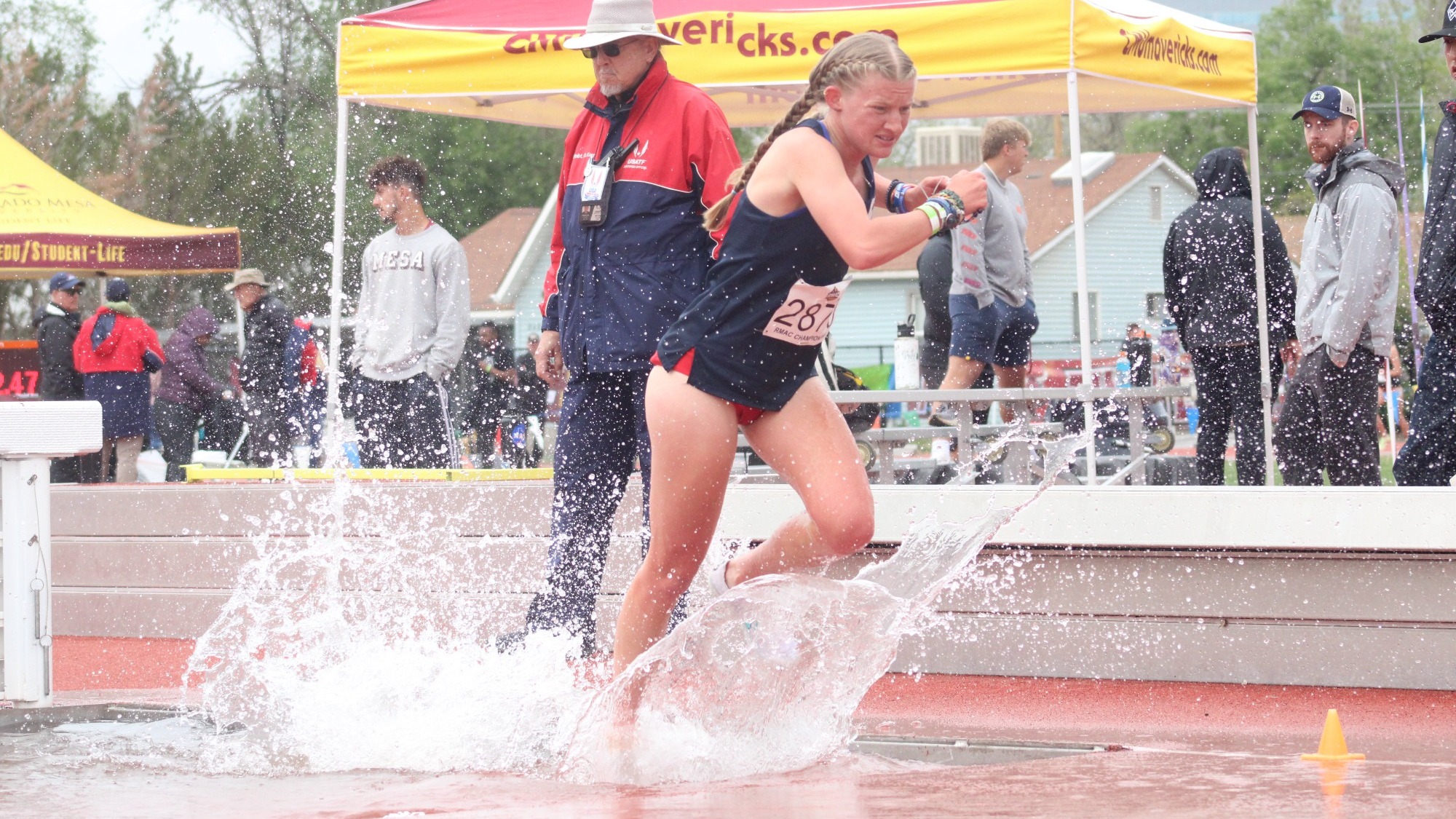 Taylor Engram splashes through the 3,000-meter steeplechase at the RMAC Championships on April 27, 2024.