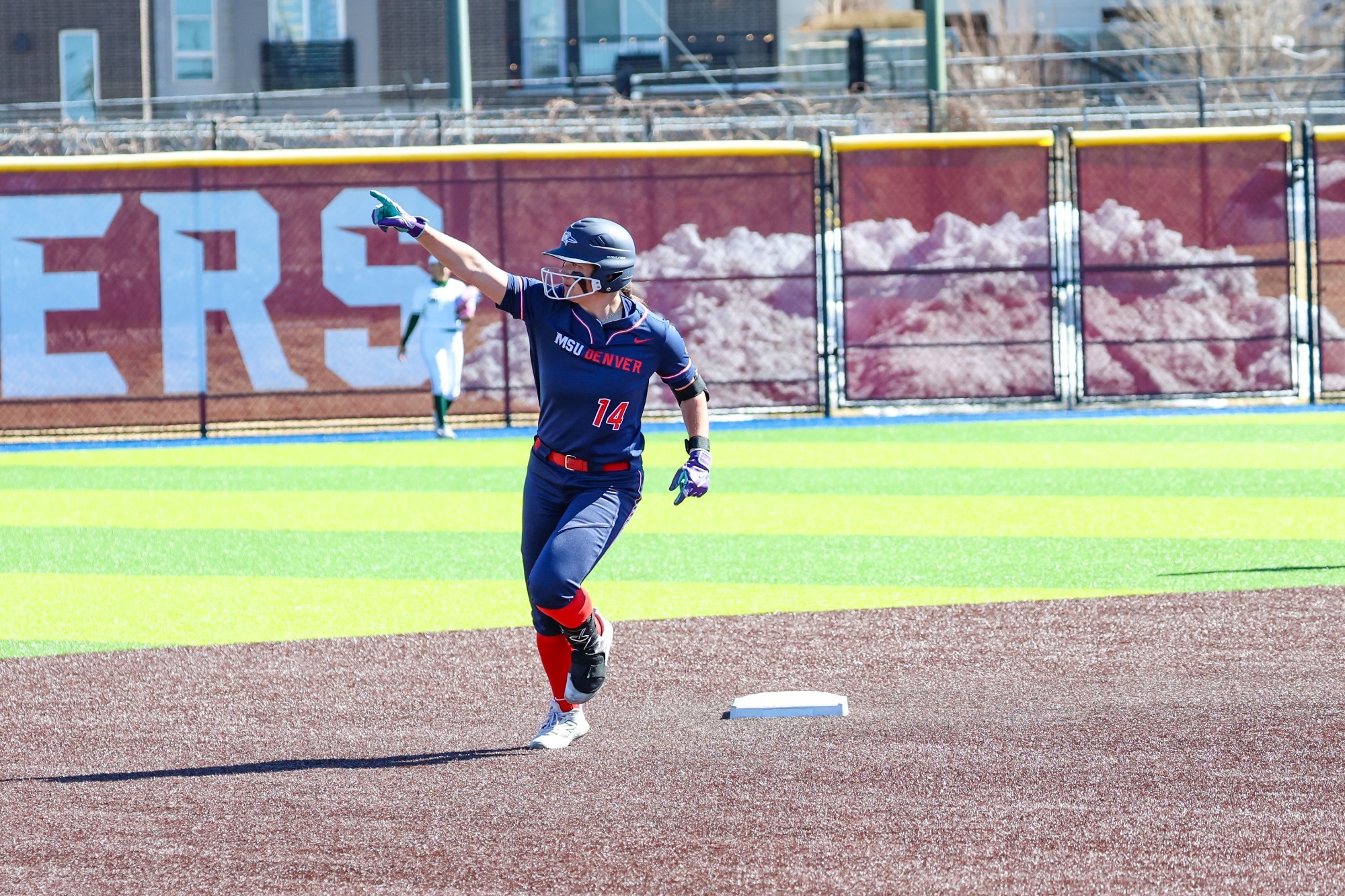 Trinity Kennemer points to the outfield after hitting a home run