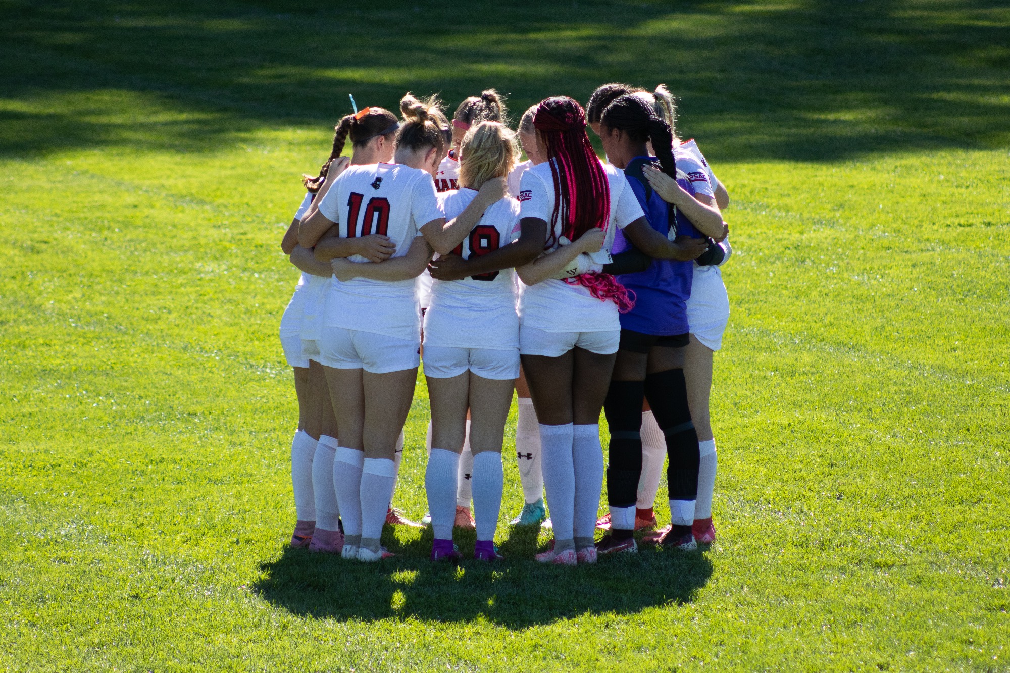 The starting Mansfield WSOC players huddle before the game begins vs Bloomsburg