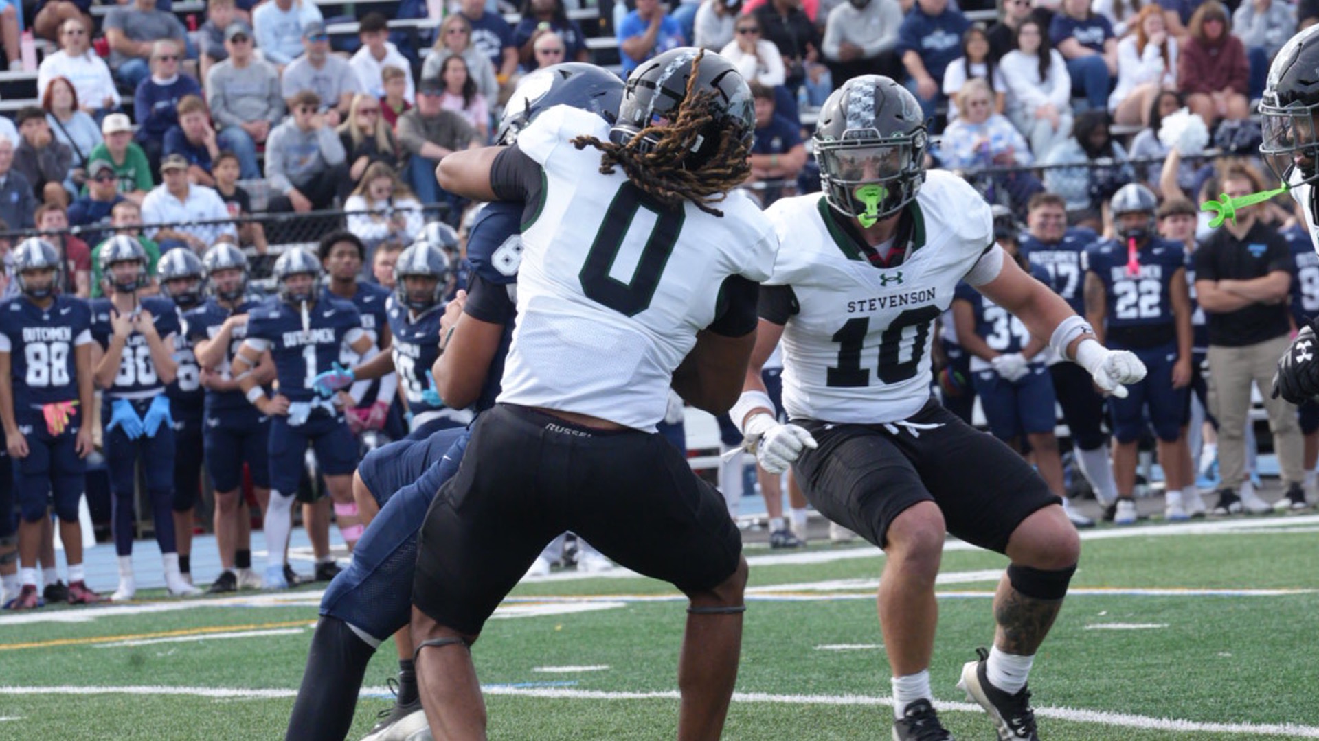 Franklin taking the quarterback down for a sack as Berry Looks on
