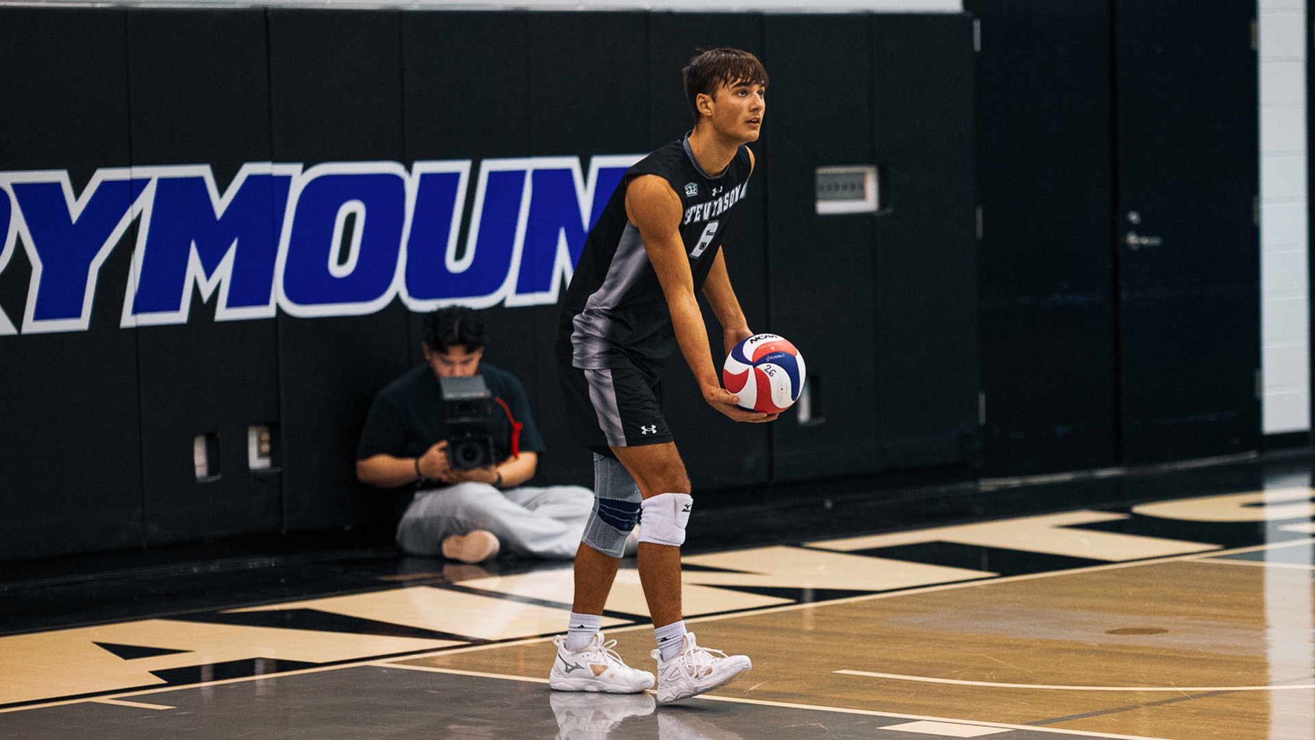 Laukuff bouncing the ball, getting ready to serve
