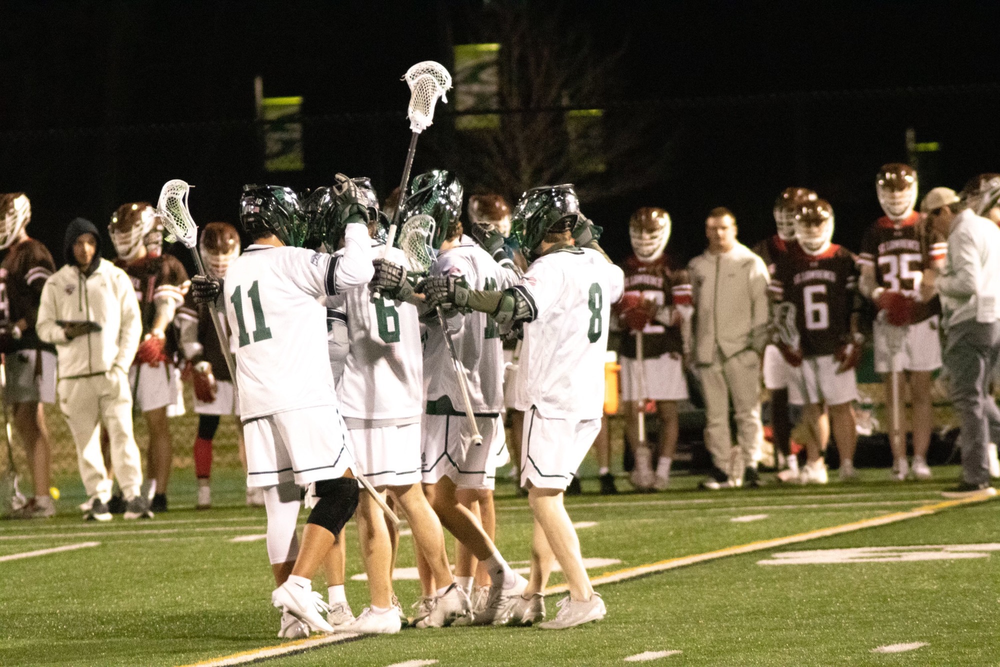 Men's Lacrosse huddle following goal