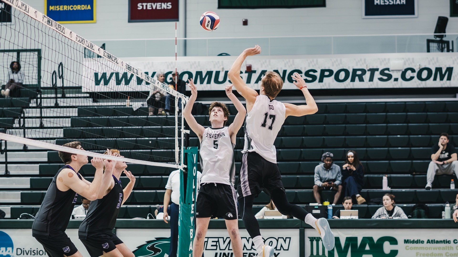 Sawyer jumping up to hit the ball coming from Roth at the net