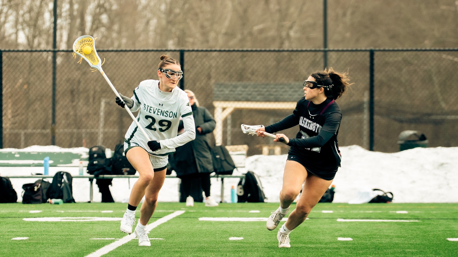 Megan Greenwell taking the ball down field in women's lacrosse