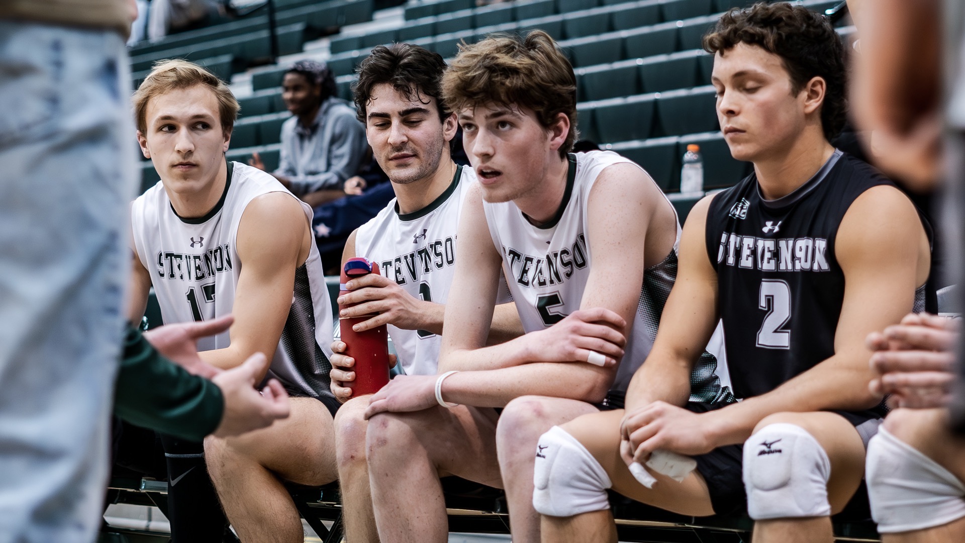 Roth tuned into coach as he is joined by his teammates on the bench, during a timeout