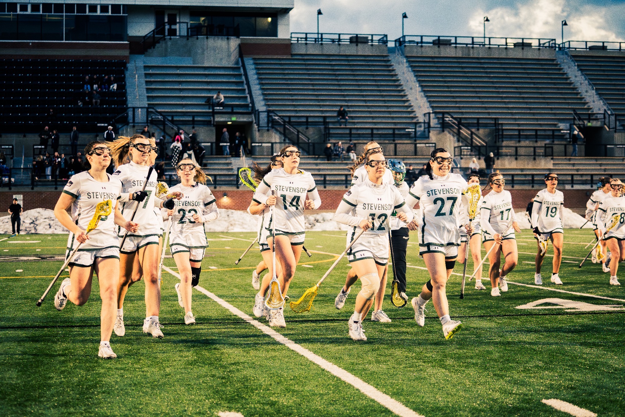 Women's Lacrosse running across field after anthem