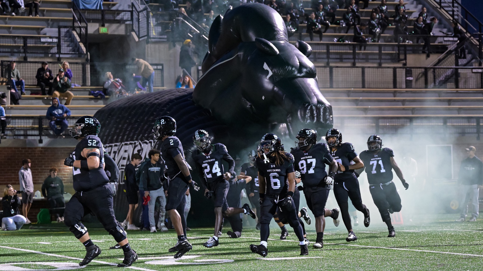 Players running out of tunnel as the team is being announced onto the field