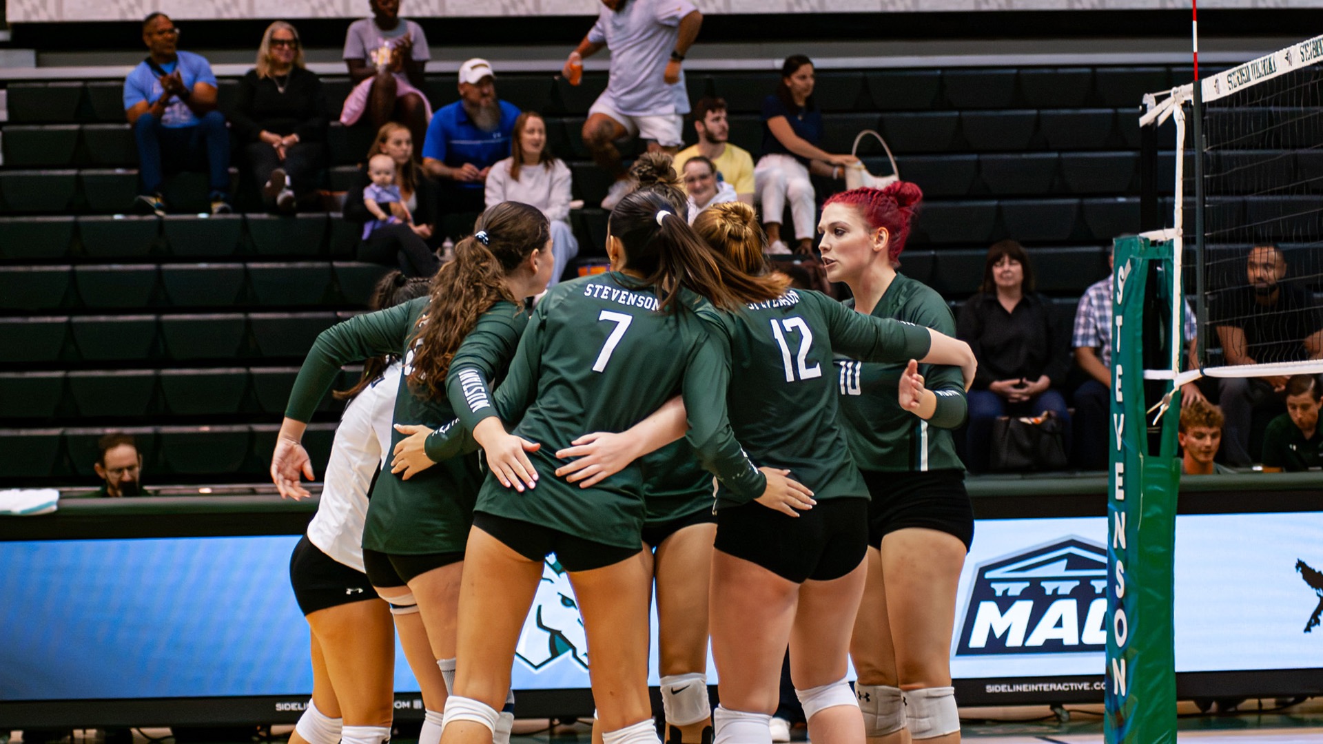 Women's Volleyball team huddle