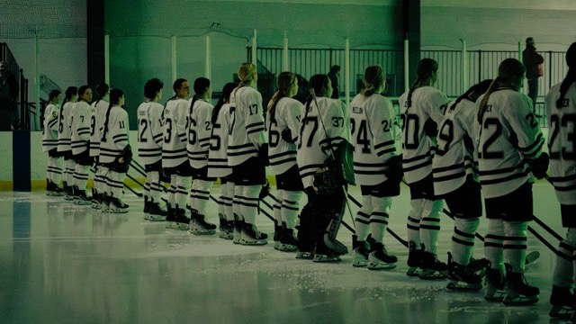 Women's Ice Hockey team standing for the national anthem 