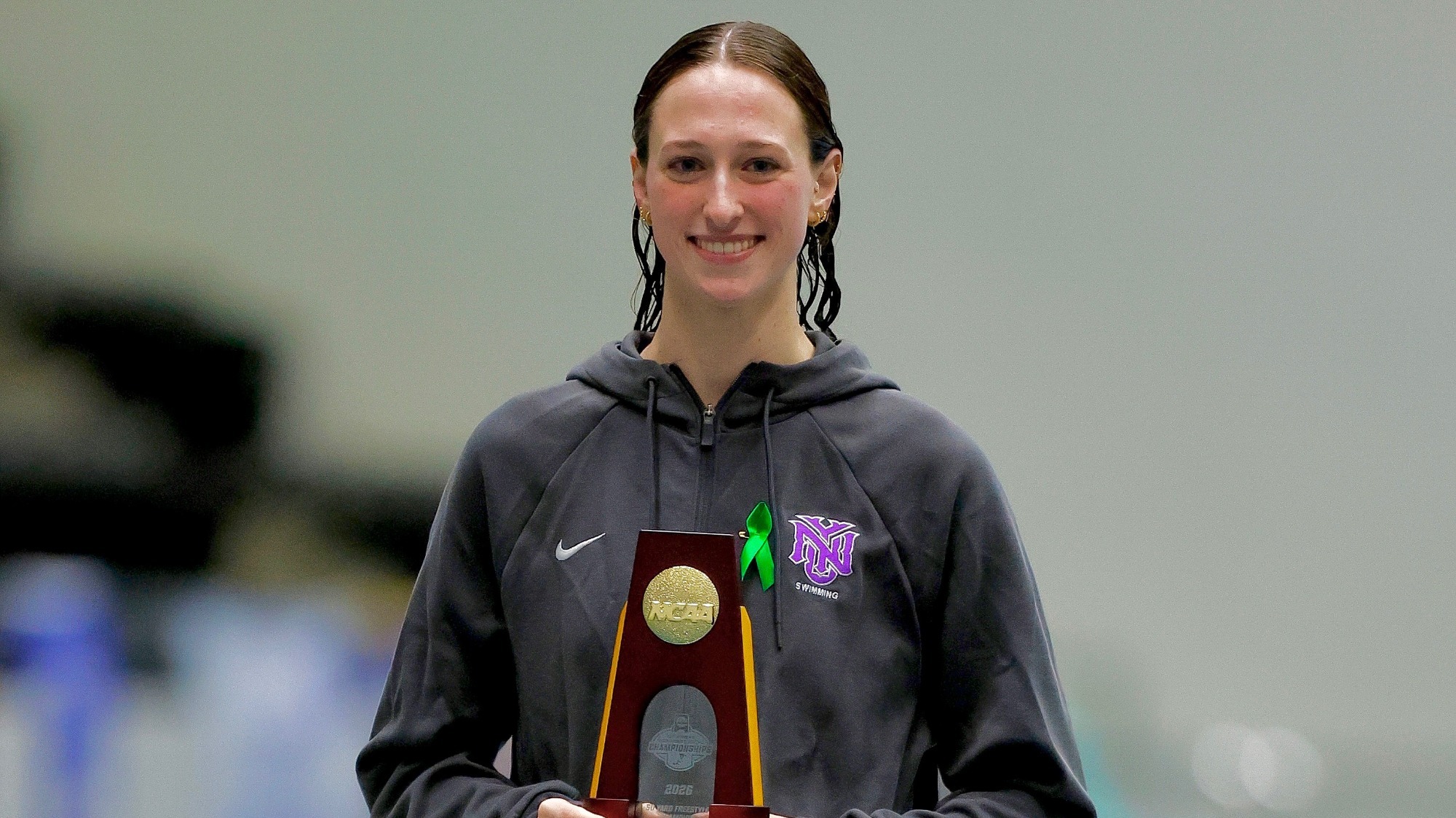 Kaley McIntyre receives her first place trophy in the 50 freestyle at the 2026 NCAA DIII National Championships