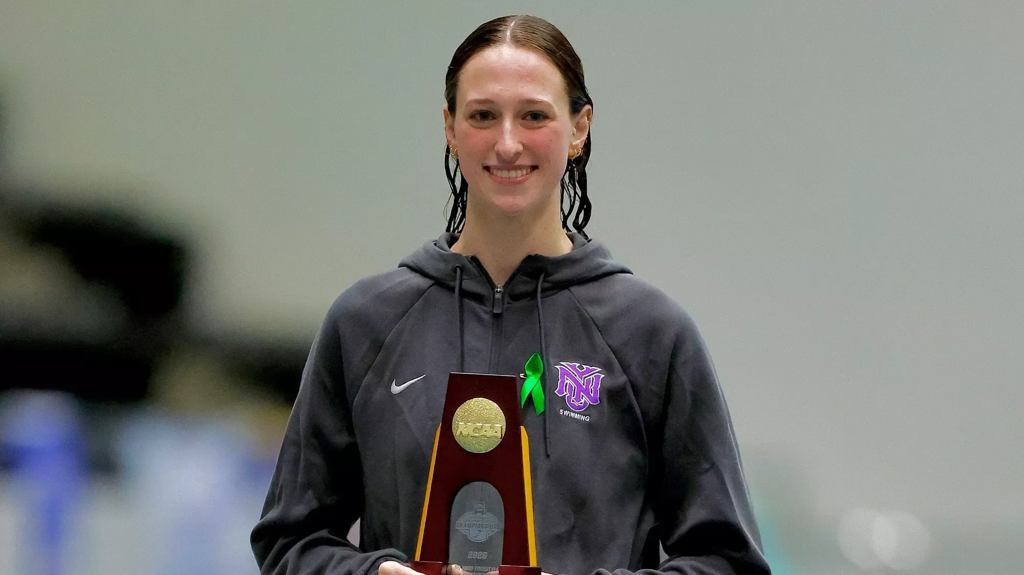 Kaley McIntyre receives her first place trophy in the 50 freestyle at the 2026 NCAA DIII National Championships
