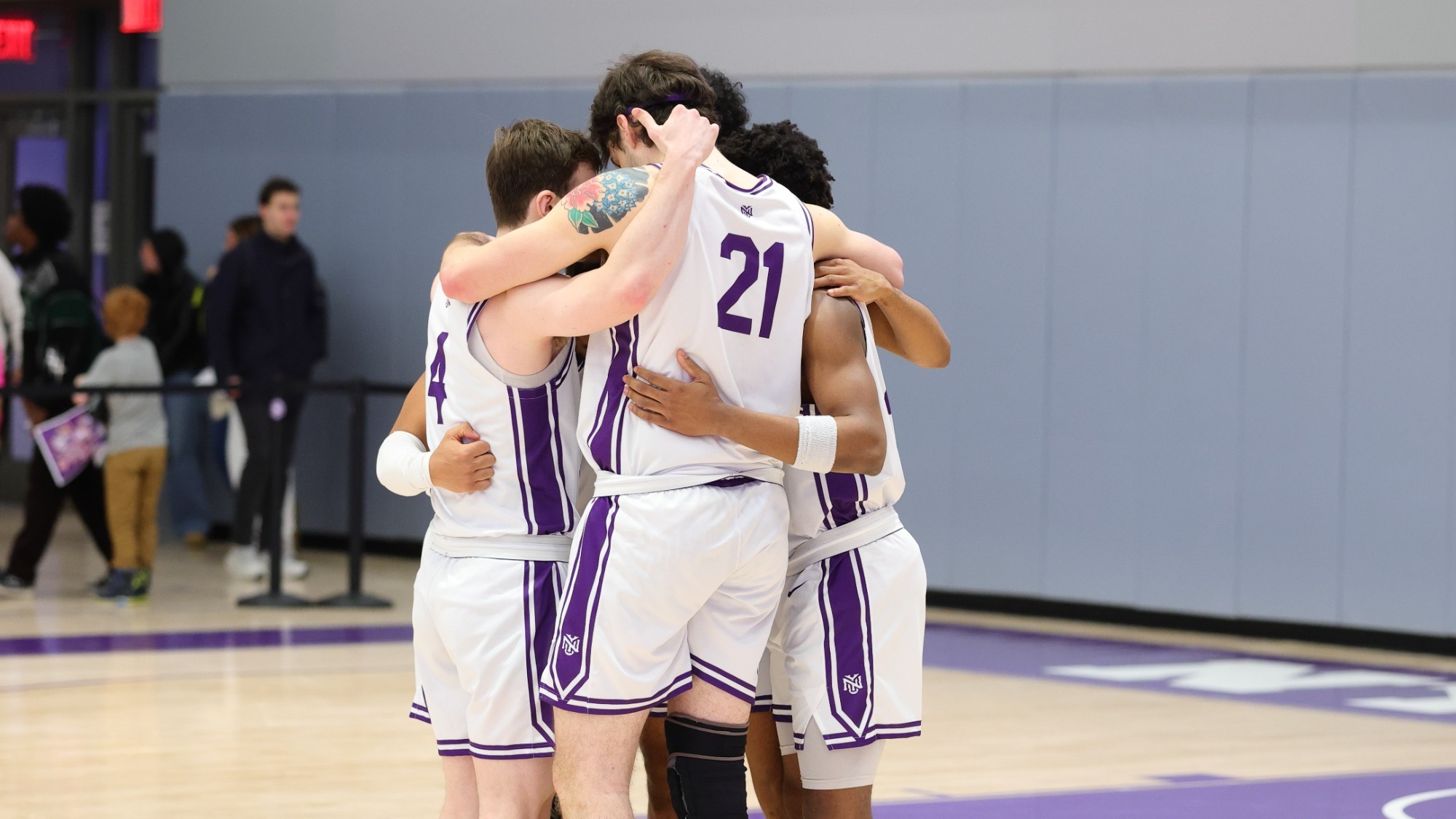 Men's basketball huddles before game