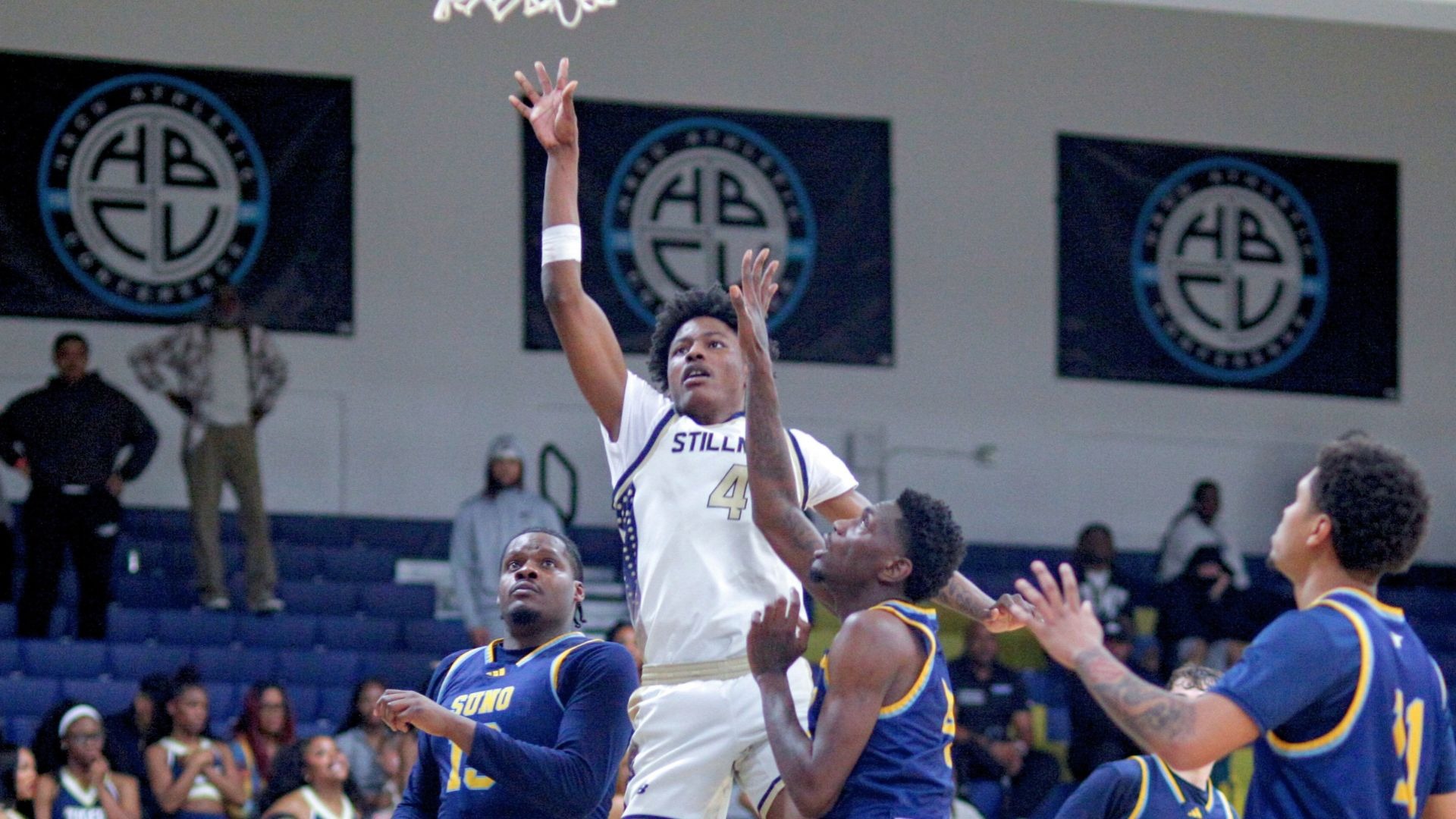 Dasean Sellers rises above SUNO for a shot 