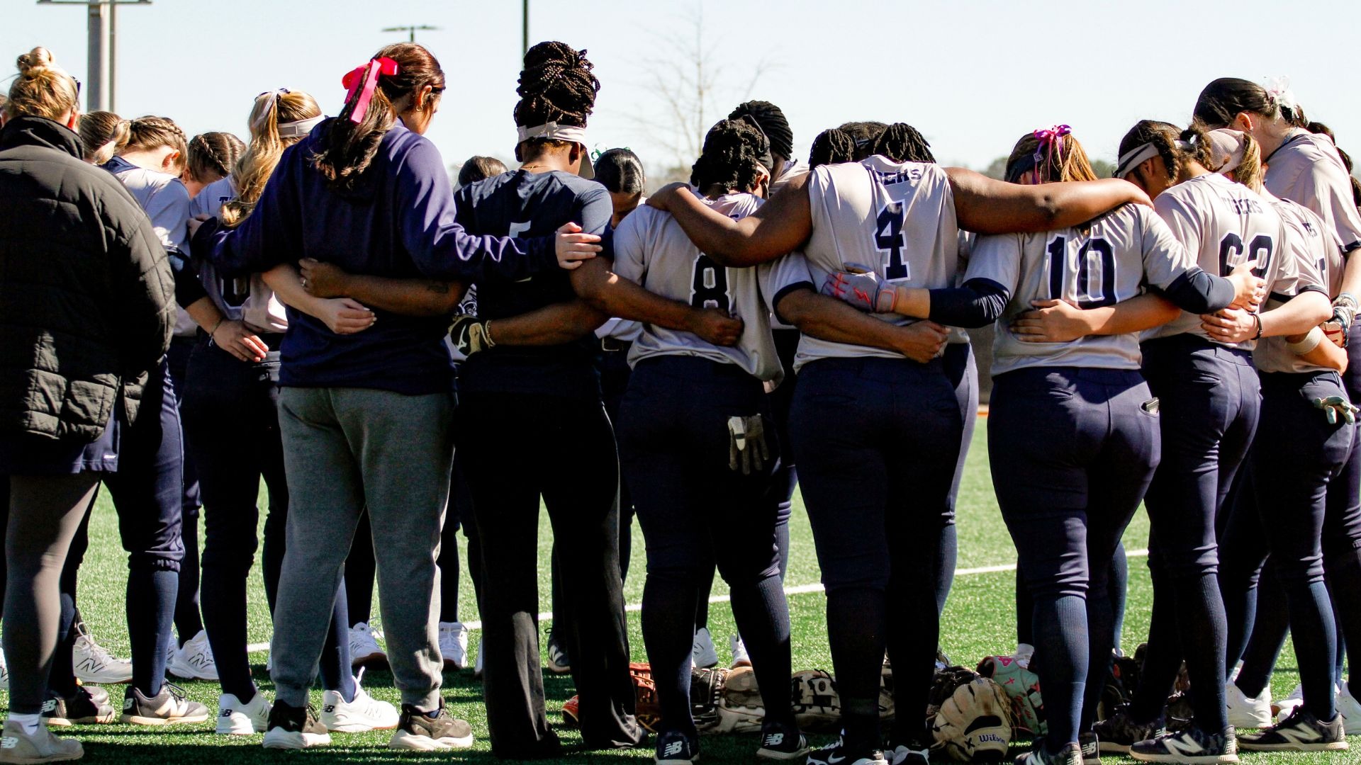 Stillman College softball team prays following a game