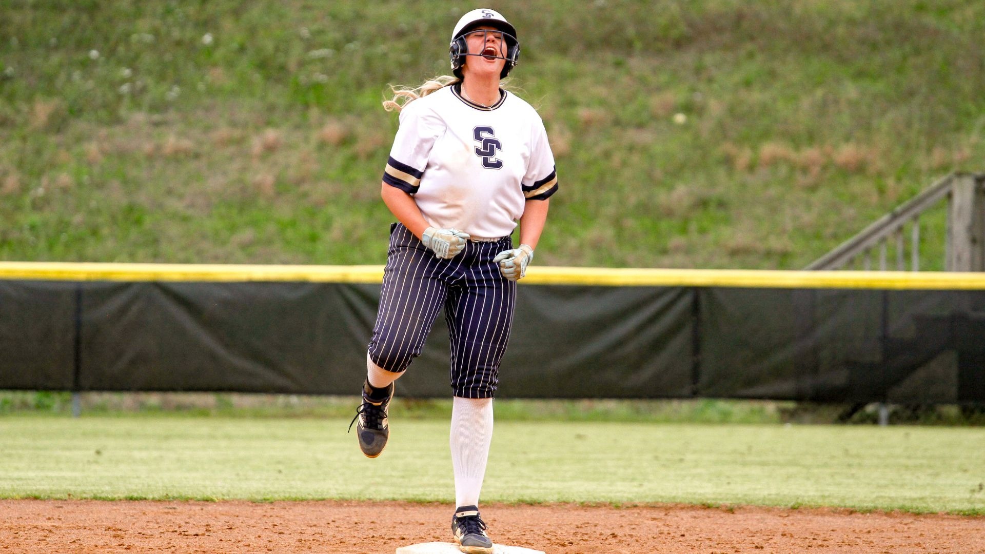 Anna Sullivan celebrates reaching base