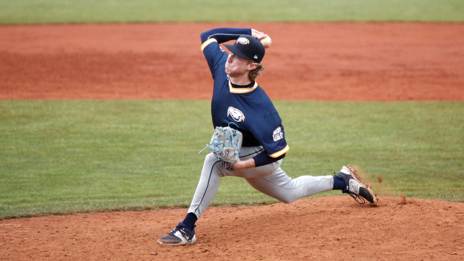 Daniel Orfaly delivering a pitch, at maximum stride, arm fully cocked back, a look of exertion on his face