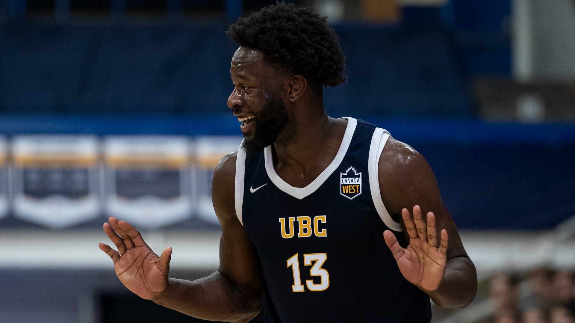 Tobi Akinkunmi laughs while putting his hands up during the game