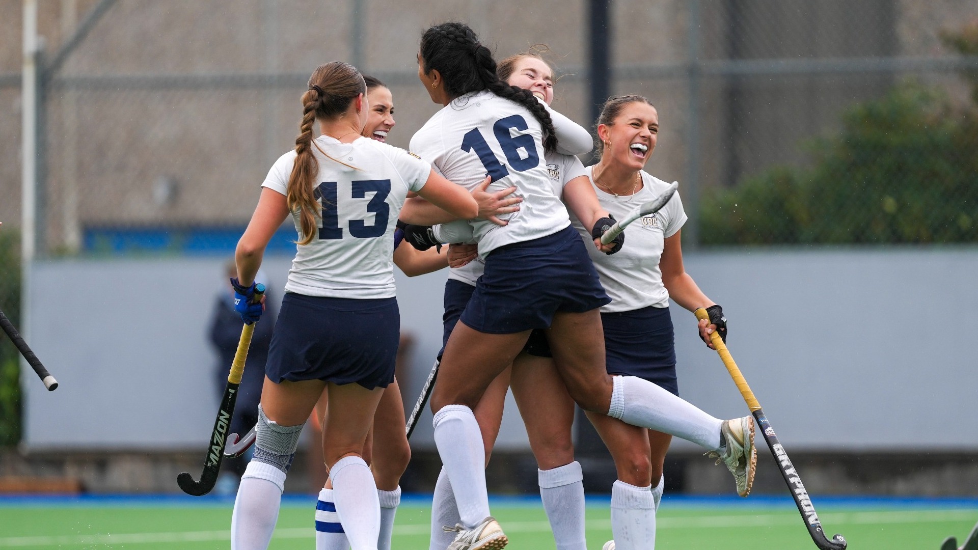 A group of T-Birds hug to celebrate after scoring a goal