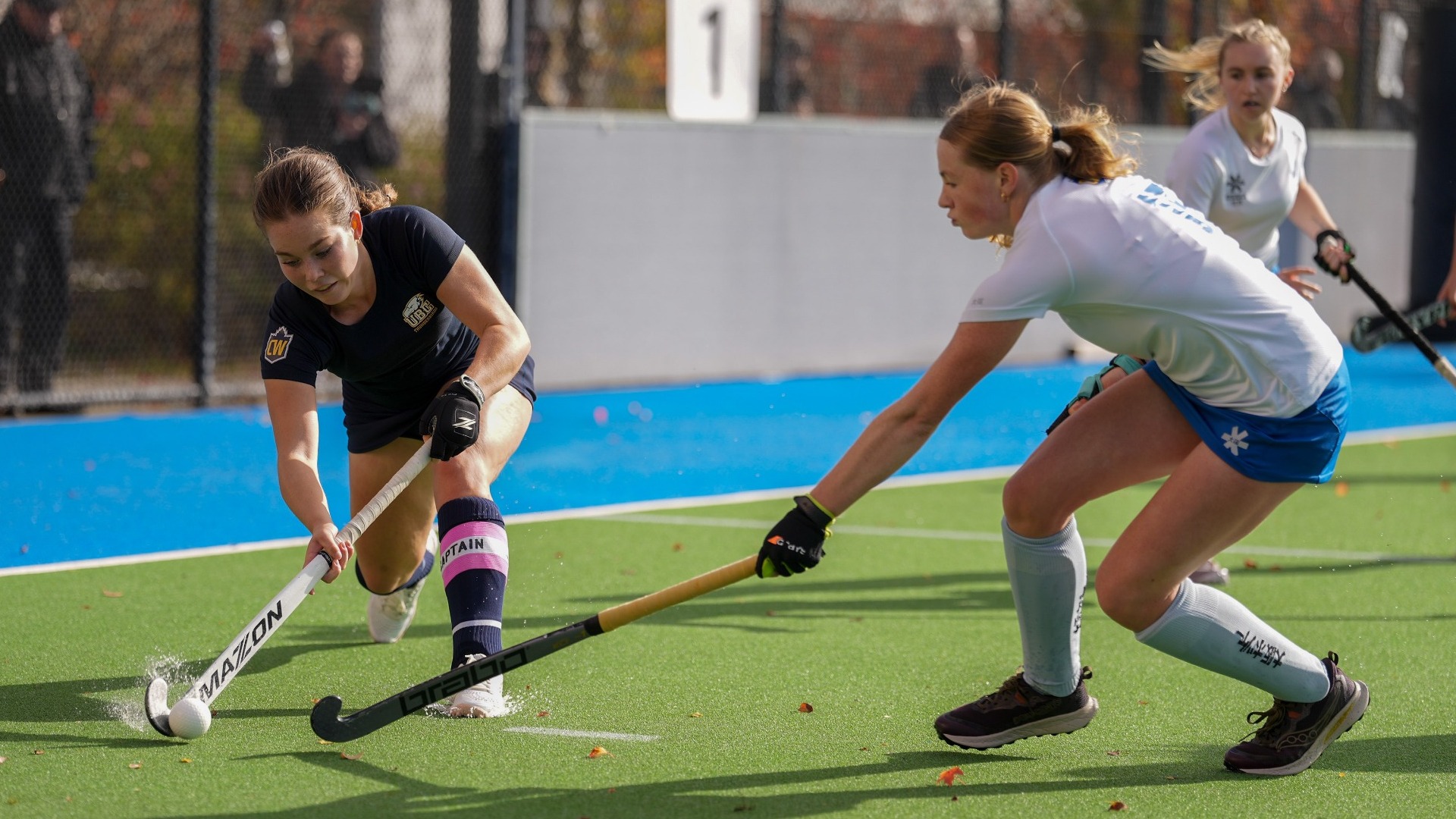 Mikayla Stelling is about to try and clear the ball down the sideline with a defender pressuring her