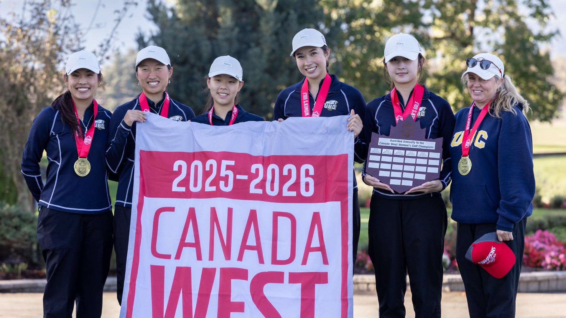 UBC Thunderbirds women's golf smile and pose with the Canada West Championship banner after winning their sixth consecutive conference title