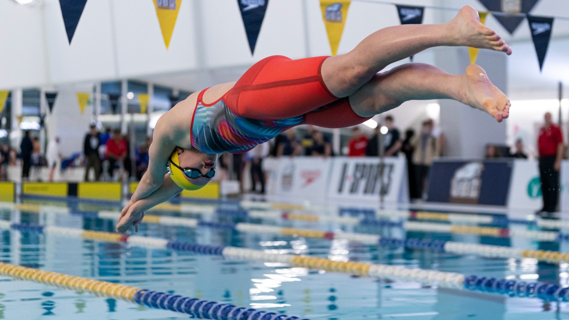 Ruby Kehler is suspended in the air as she dives into the water