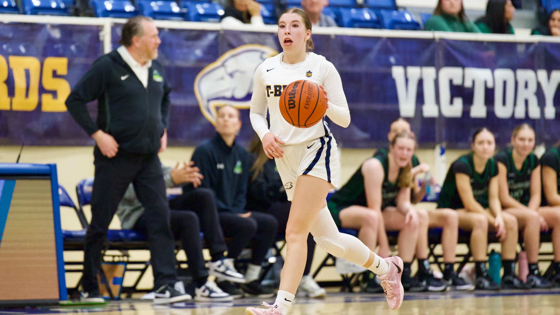 Cerys Merton dribbles the ball up the court