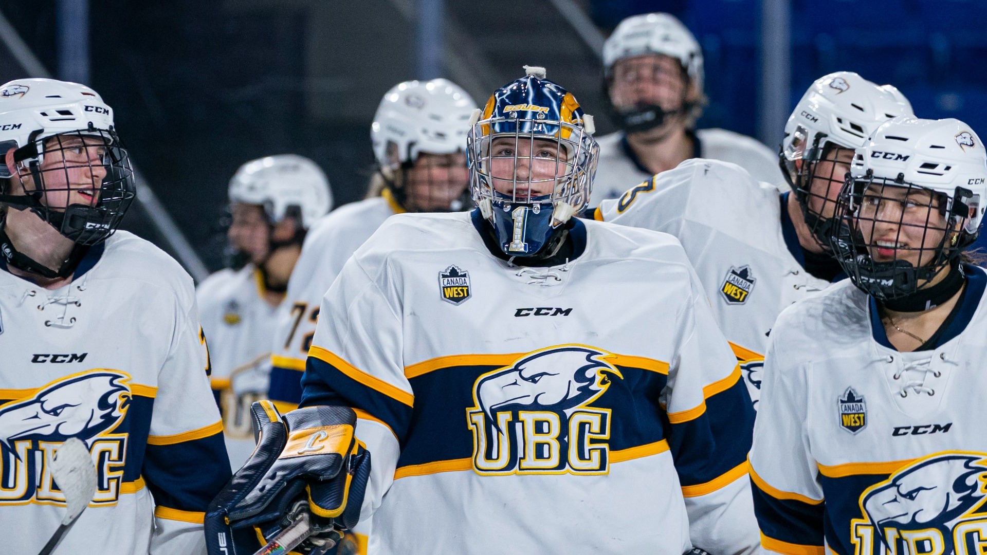 A group of T-Birds all stand next to each other with their helmets on