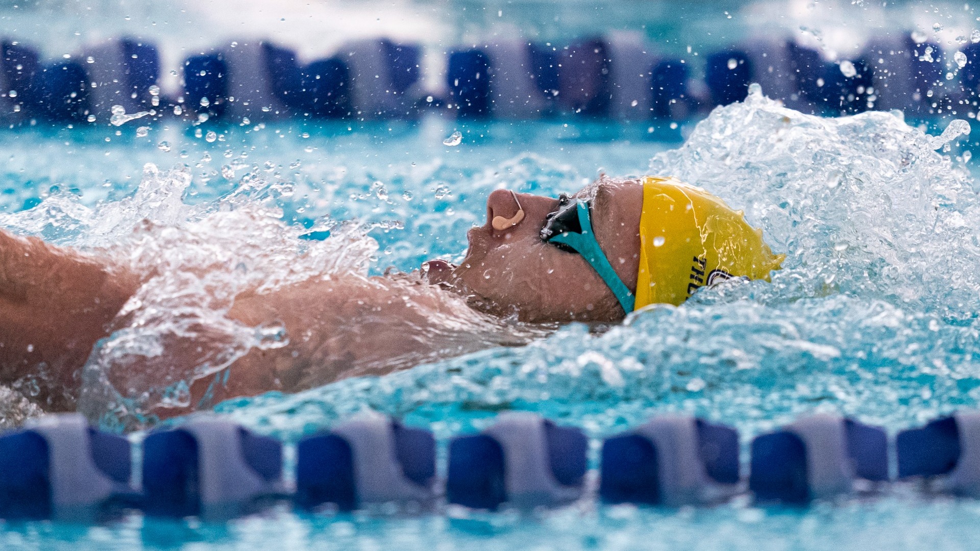Blake Tierney doing the backstroke at the CW Championships