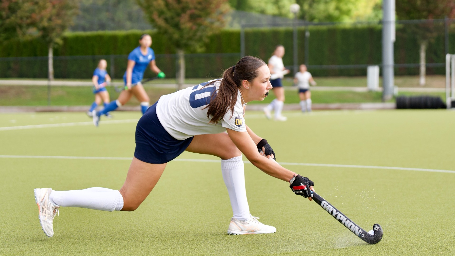Maia Lawrence stoops down to knock the ball forwards