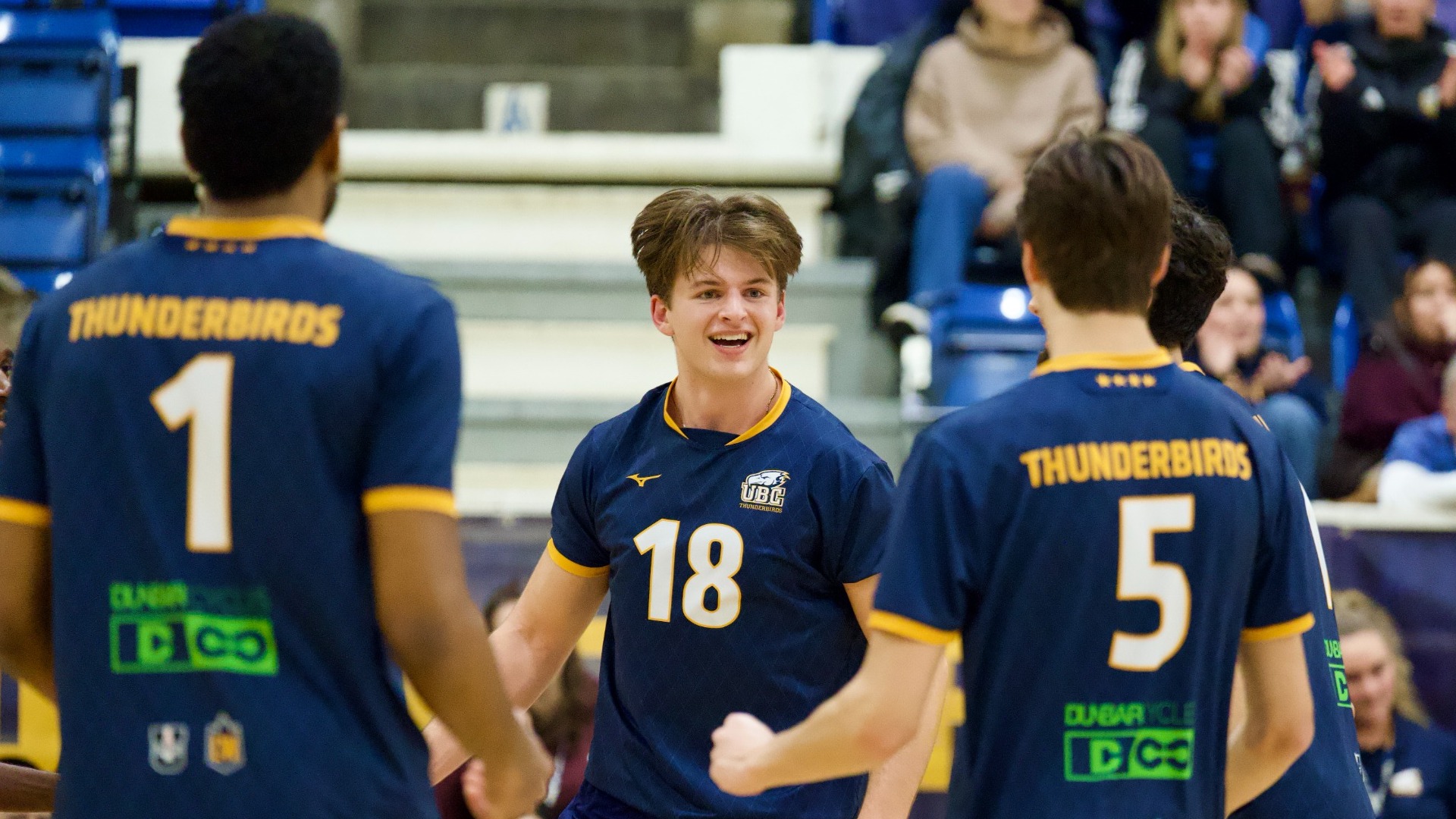 Alex Borowski is happy between plays with a few teammates facing him with their backs to the camera