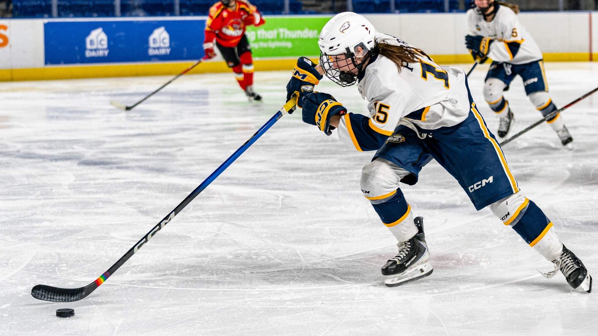 Hanna Perrier drives forward with the puck in the middle of the ice