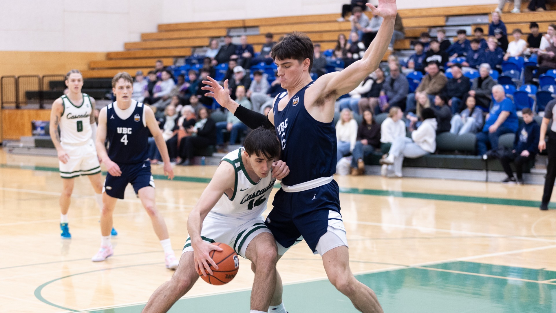 A UBC defender walls up on the inside to prevent a UFV guard from dribbling past him